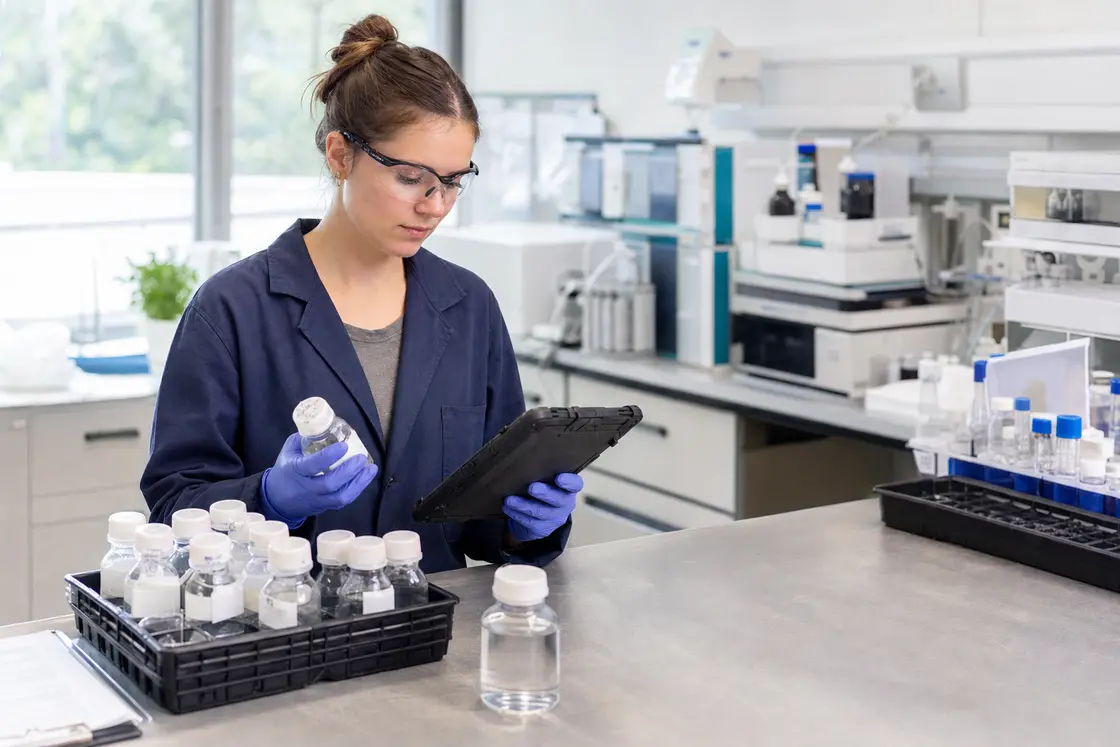 Laboratory technician cataloguing environmental sample bottles